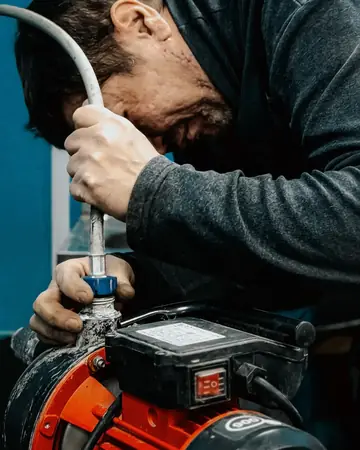 A plumber working on a water pump